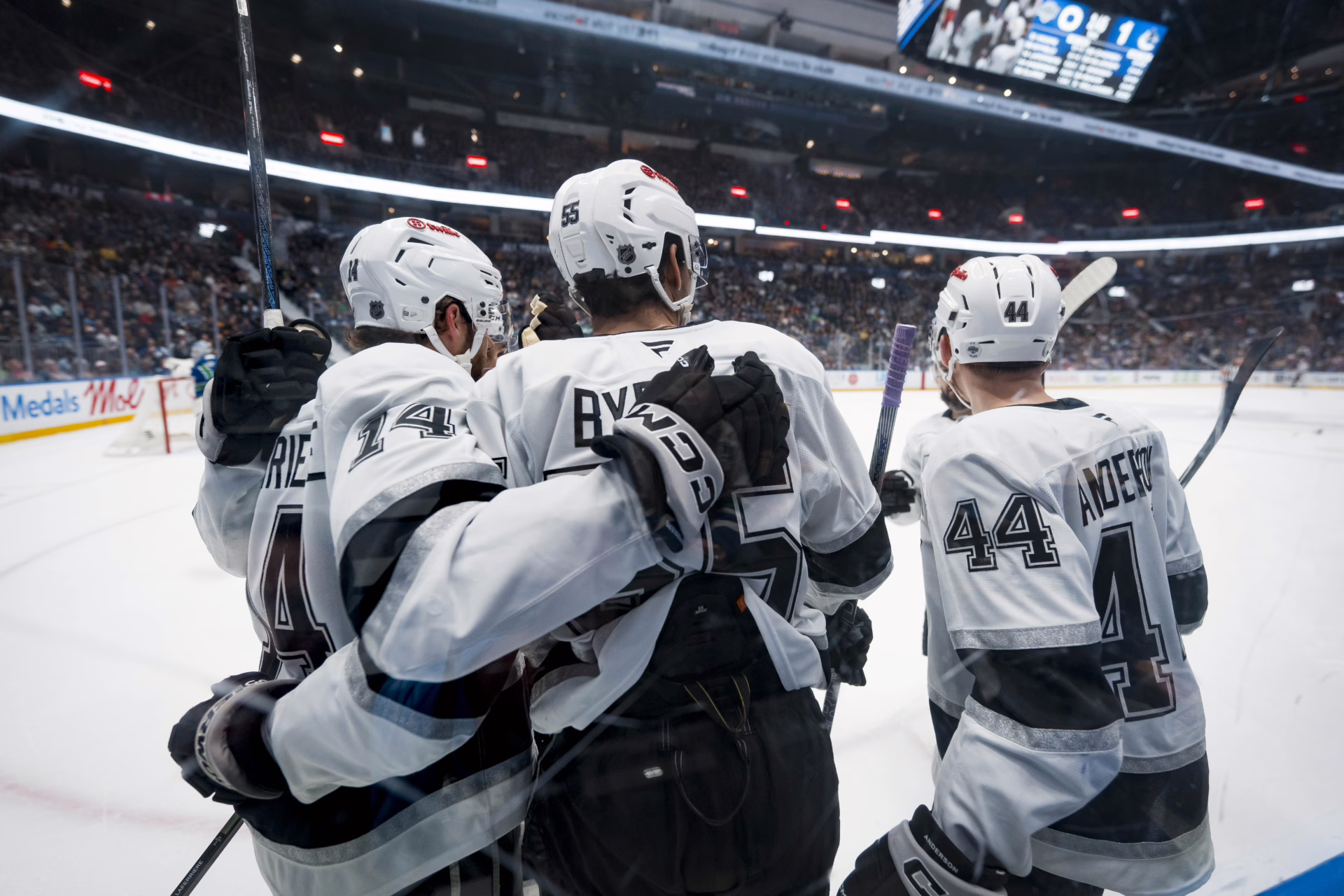 Apr 14, 2026; Vancouver, British Columbia, CAN; Los Angeles Kings forward Alex Laferriere (14) and forward Quinton Byfield (55) and defenseman Mikey Anderson (44) celebrate Byfield’s goal against the Vancouver Canucks in the first period at Rogers Arena. Mandatory Credit: Bob Frid-Imagn Images