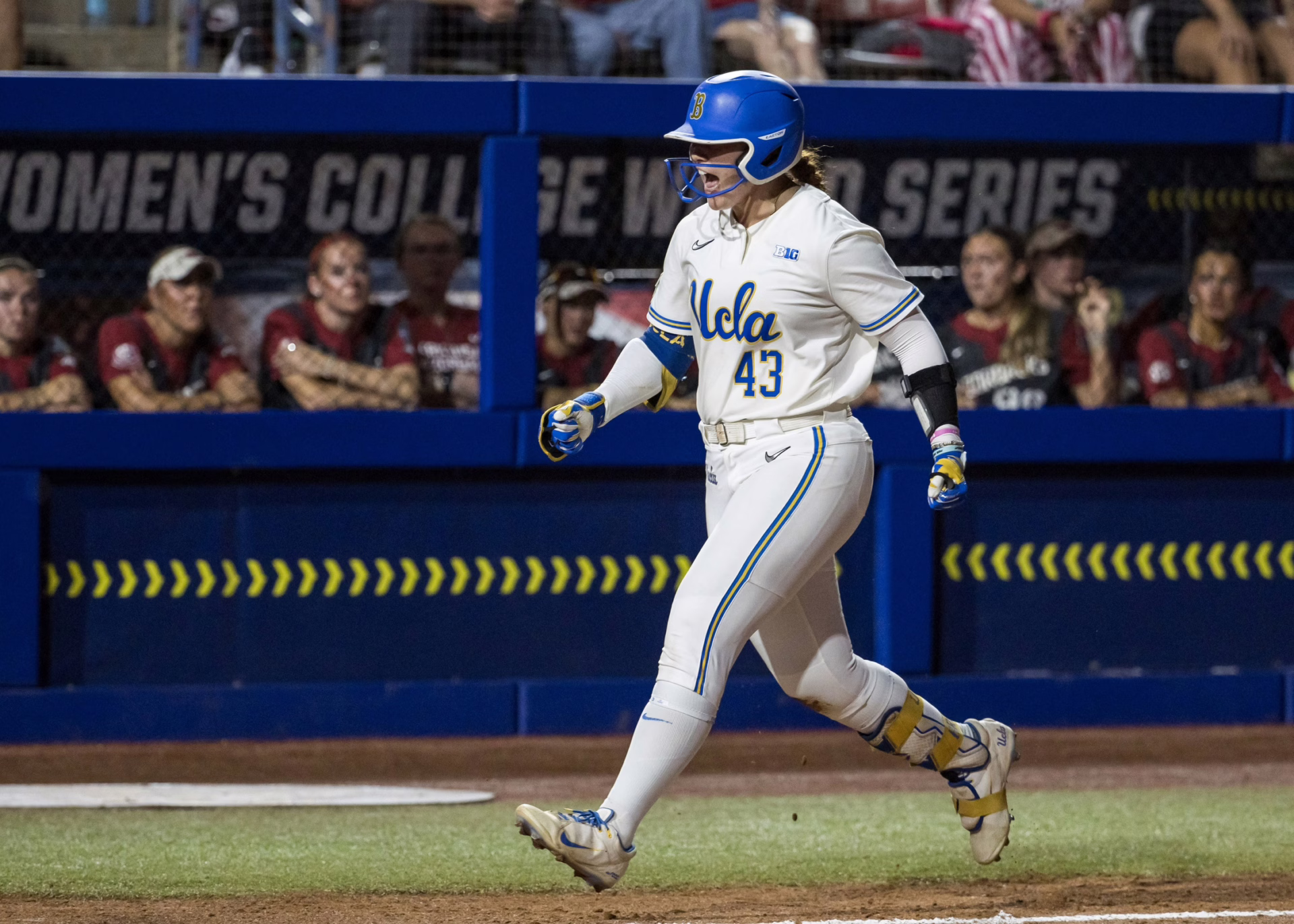 UCLA Bruins utility Megan Grant (43) yells as she heads towards home plate after hitting a three run home run in the second inning against the Arkansas Razorbacks during the NCAA Women’s College World Series at Devon Park.