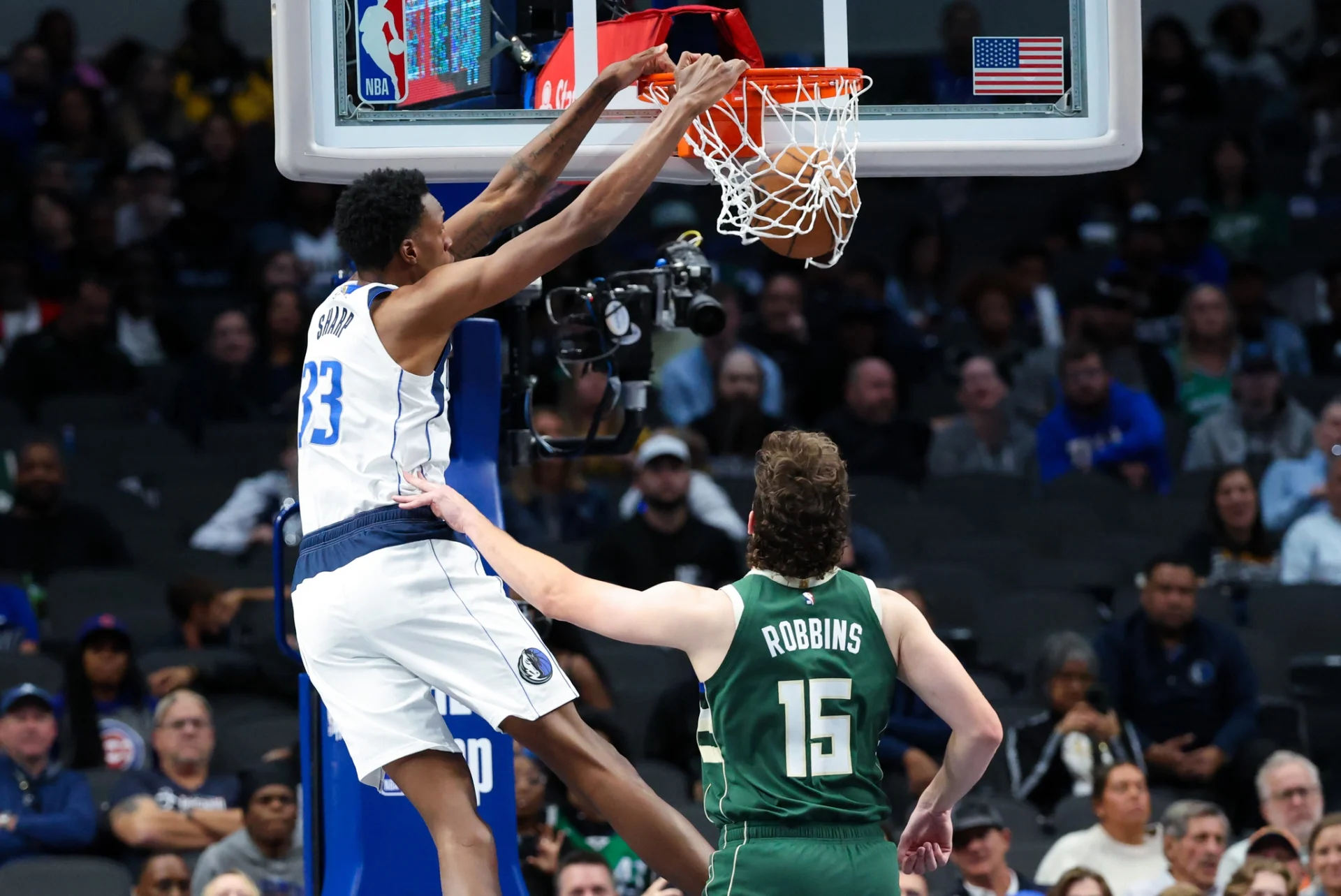 Dallas Mavericks center Jamarion Sharp (33) dunks past Milwaukee Bucks center Liam Robbins (15) during the second half at American Airlines Center.