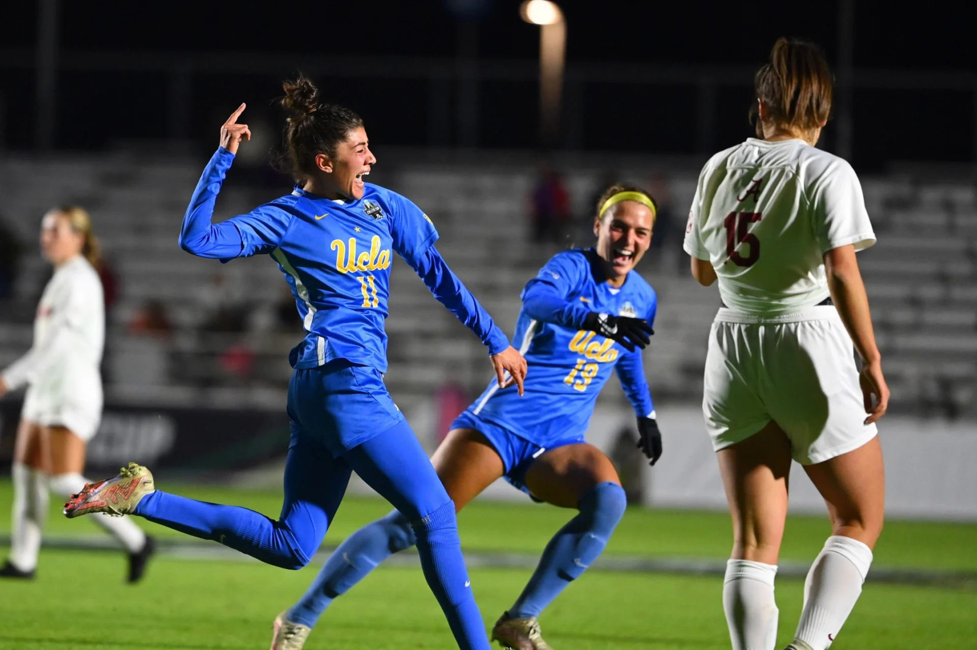 UCLA Madelyn Desiano (11) celebrates with Quincy McMahon (19) after scoring a goal as Alabama Kat Rogers (15) is in the foreground in the second half at WakeMed Soccer Park.